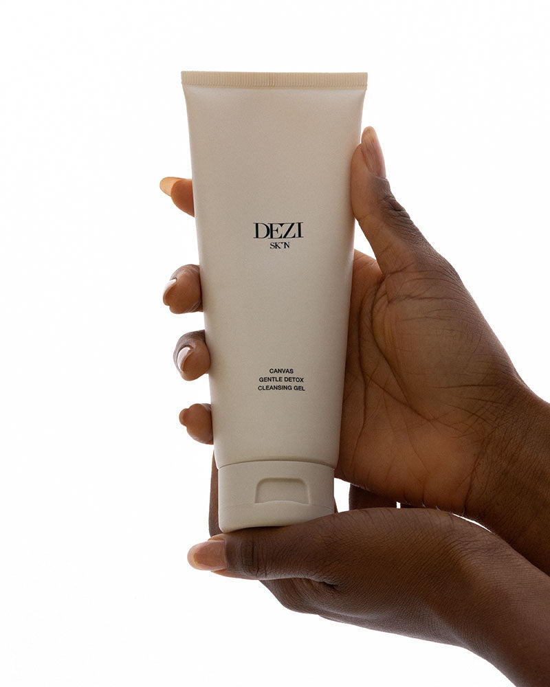 hands holding the cleanser tube.