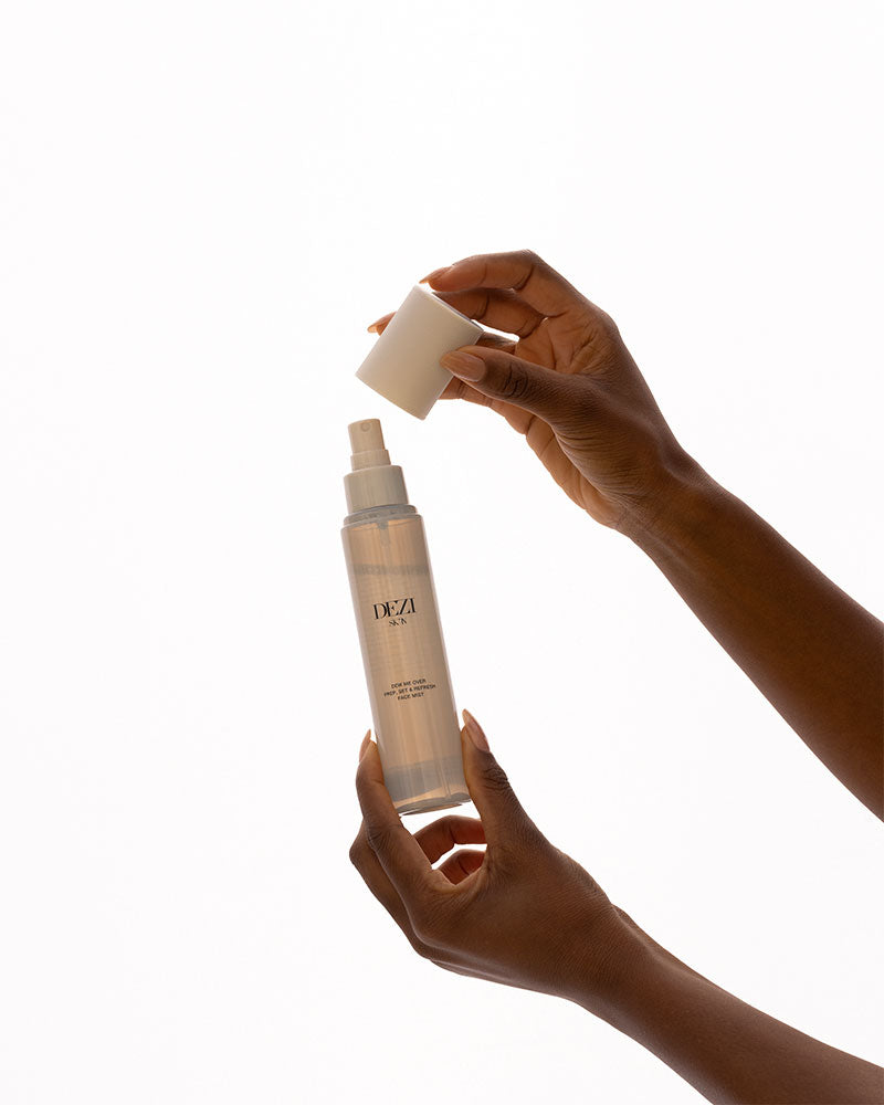 Model holding the skincare mist bottle in her hands.