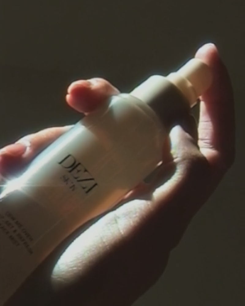 Video of model holding the skincare mist bottle in her hands.