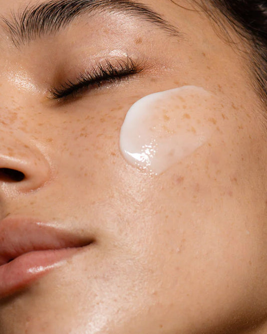 Close-up of model with a swatch of Dezi Skin Agua Fresca Thirst Quenching Gel Creme Moisturizer on cheek