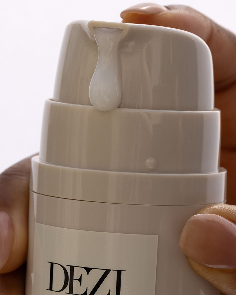 Close up image of overnight skincare moisture mask. Hand is pumping the bottle so you can see the mask coming out of the nozzle. 