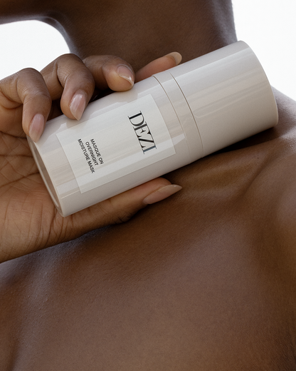 Overnight skincare Mask bottle being held in a hand. The cap is on and you can clearly see the name of the product