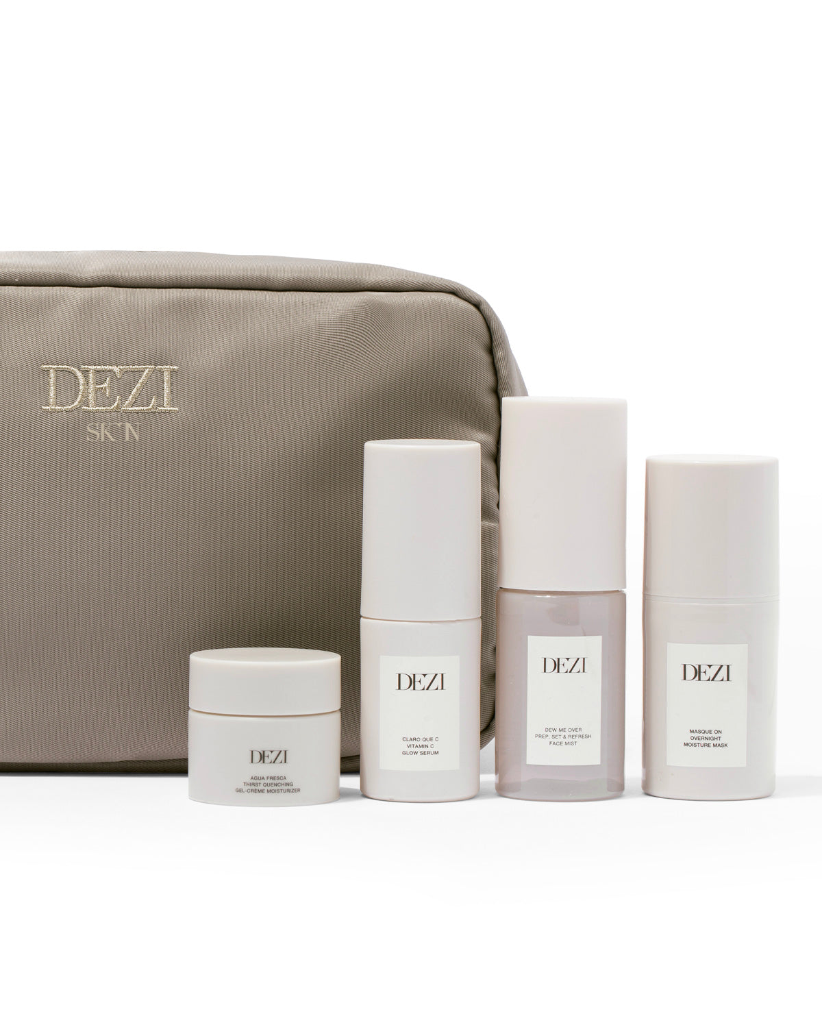 The four mini travel size skincare products are sitting in front of the travel cosmetic bag. 